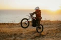 Zero XB – motocykl elektryczny enduro AM w akcji, jazda na jednym kole po szutrowej drodze.